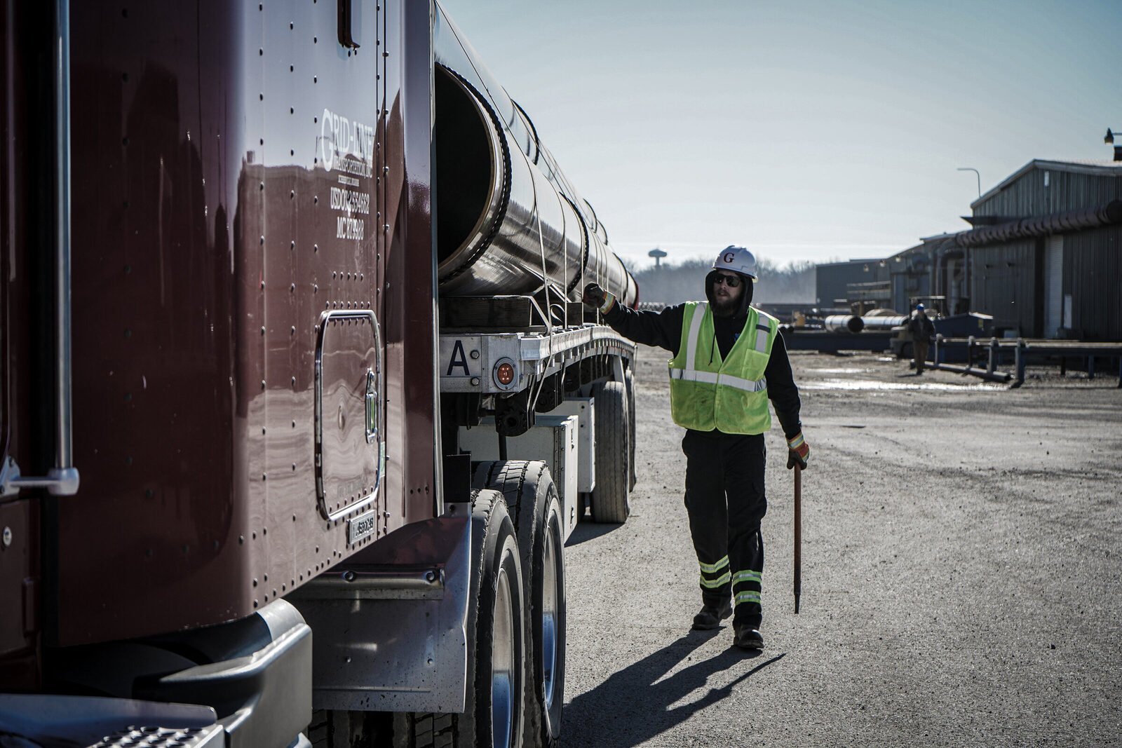 Grid-Line driver in hi-vis and hard hat at the loading yard