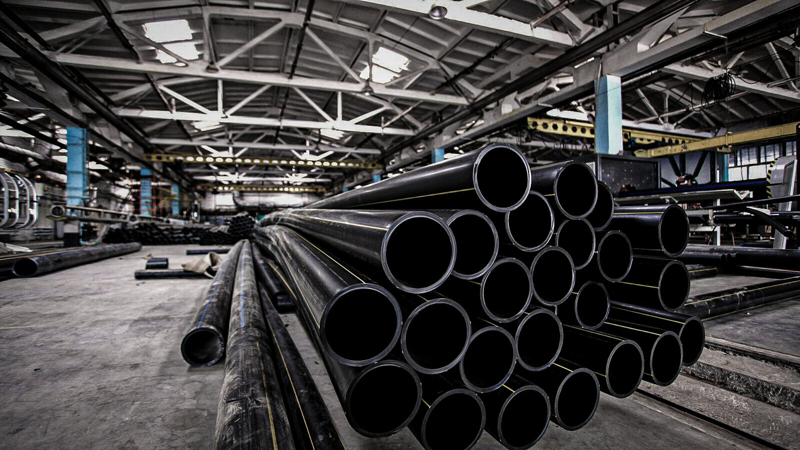Industrial pipe bundles staged at a manufacturing facility